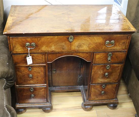 An early 18th century walnut kneehole desk, W.2ft 10in. D.1ft 6in. H.2ft 6in.